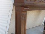 a fireplace with a wooden mantle in front of a building