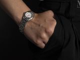 a man that is wearing a watch on his wrist