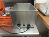 a metal sink with two water tanks on top of it