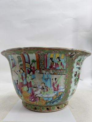 a bowl with a painting on it sitting on a white surface