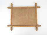 a picture of a wooden frame hanging on a wall