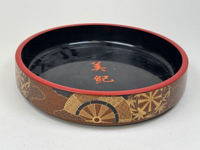 un bol noir et rouge orné d'inscriptions orientales