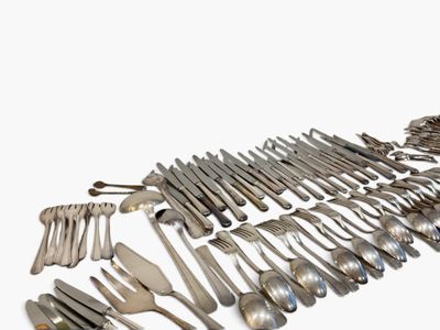 a lot of silverware on a white surface