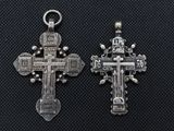 two silver crosses on a black background with a cross in the middle