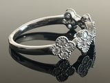 a close up of a diamond ring on a reflective surface