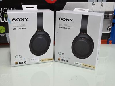 two sony wireless headphones are sitting on a table in a store