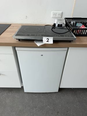 a small kitchen with a stove and a dishwasher on the counter