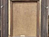 an old picture frame with a piece of burlock on it