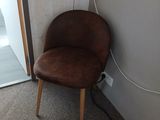 a brown chair sitting in front of a door