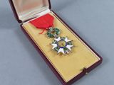 a medal in a case with a red ribbon around it