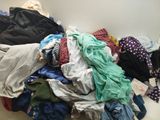 a pile of clothes sitting on the floor next to a wall