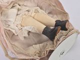 a doll that is sitting inside of a basket