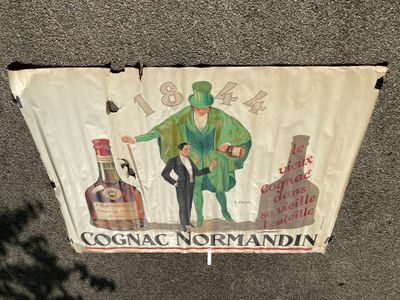 a sign on the side of a building that says cognac norman