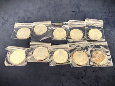 a bunch of gold coins in plastic bags sitting on a table