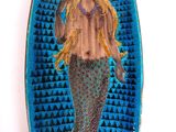 blue and green plate with a mermaid holding a fish on it ' s back