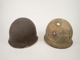 two helmets are sitting next to each other on a white surface