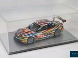 a model of a colorful sports car in a clear display case