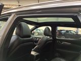 the interior of a car with the door open and the driver ' s seat down