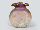 a purple vase with flowers on it sitting on a white surface