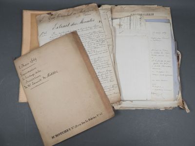 several old papers are stacked on top of each other on a table