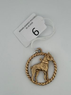 a close up of a gold ornament with a horse on it