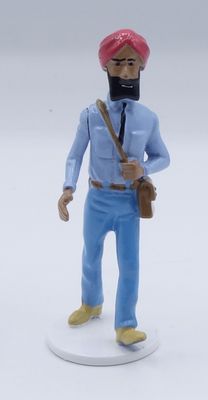 a figurine of a man with a pink turban on his head