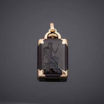 a gold and black onyxite pendant with an image of a woman