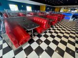 a black and white checkered floor with red booths