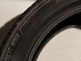 a tire that is sitting on the floor next to a wall