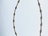 an image of a gold necklace on a white background
