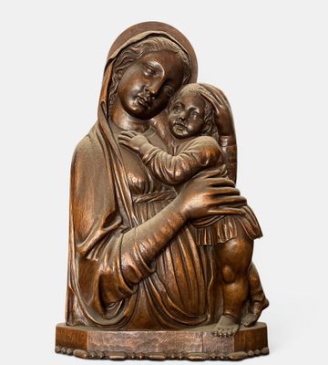 a statue of a woman holding a child in her arms
