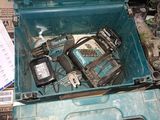 a blue tool box filled with tools on top of a pile of papers