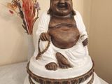 a statue of a laughing buddha sitting on a table