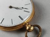a close up of a pocket watch on a table