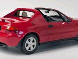 a red car that is sitting on a white surface