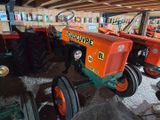 many tractors that are parked in a garage