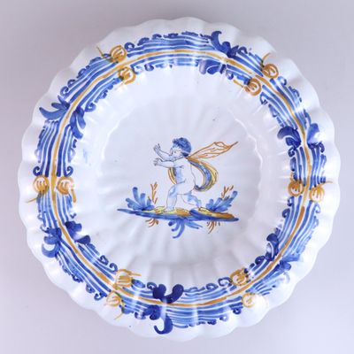 a blue and yellow plate with a dragon on it