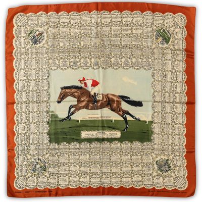 a close up of a horse and jockey on an orange background