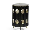 an image of a black and gold side table with holes on it