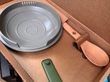 a box with a pan, spoon, and other items in it
