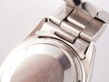 a close up of a watch on a white surface