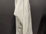 a white shirt on a mannequin stand in front of a black wall