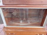 a wooden cabinet with a glass display case on it