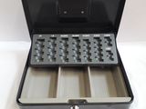 a black briefcase with keys in it on a table