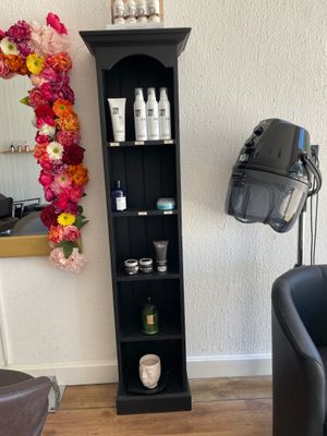 a black chair in a room with a mirror on the wall