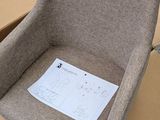 a brown chair that is sitting on a cardboard box