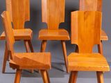four chairs with wooden legs and a wooden seat on a gray surface