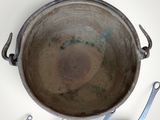 a lot of pots and pans that are hanging on the wall