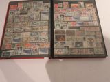an open book with stamps on it on a table