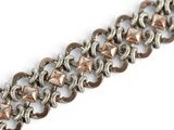 a close up of a metal chain bracelet with a square clasp